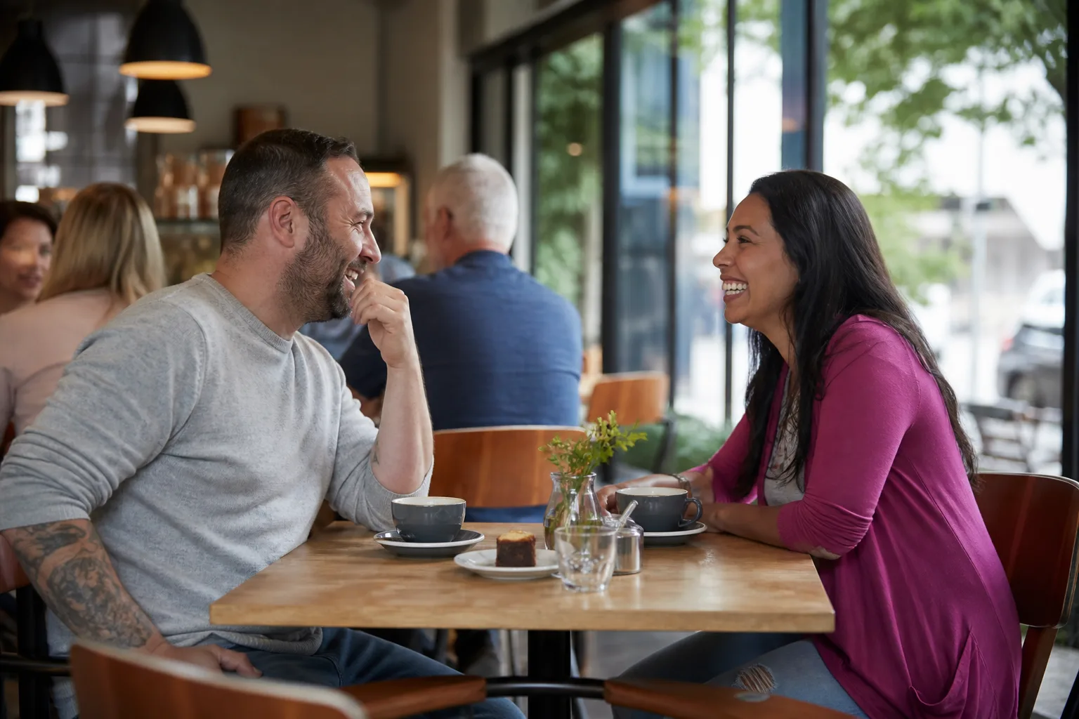 Two people talking beside the River Cam in Cambridge